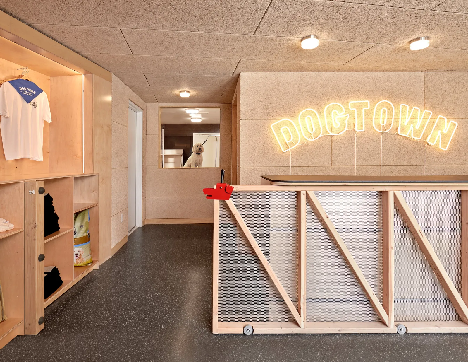 wood-framed gate with translucent panels, a red latch, and a yellow neon DOGTOWN sign on the reception wall