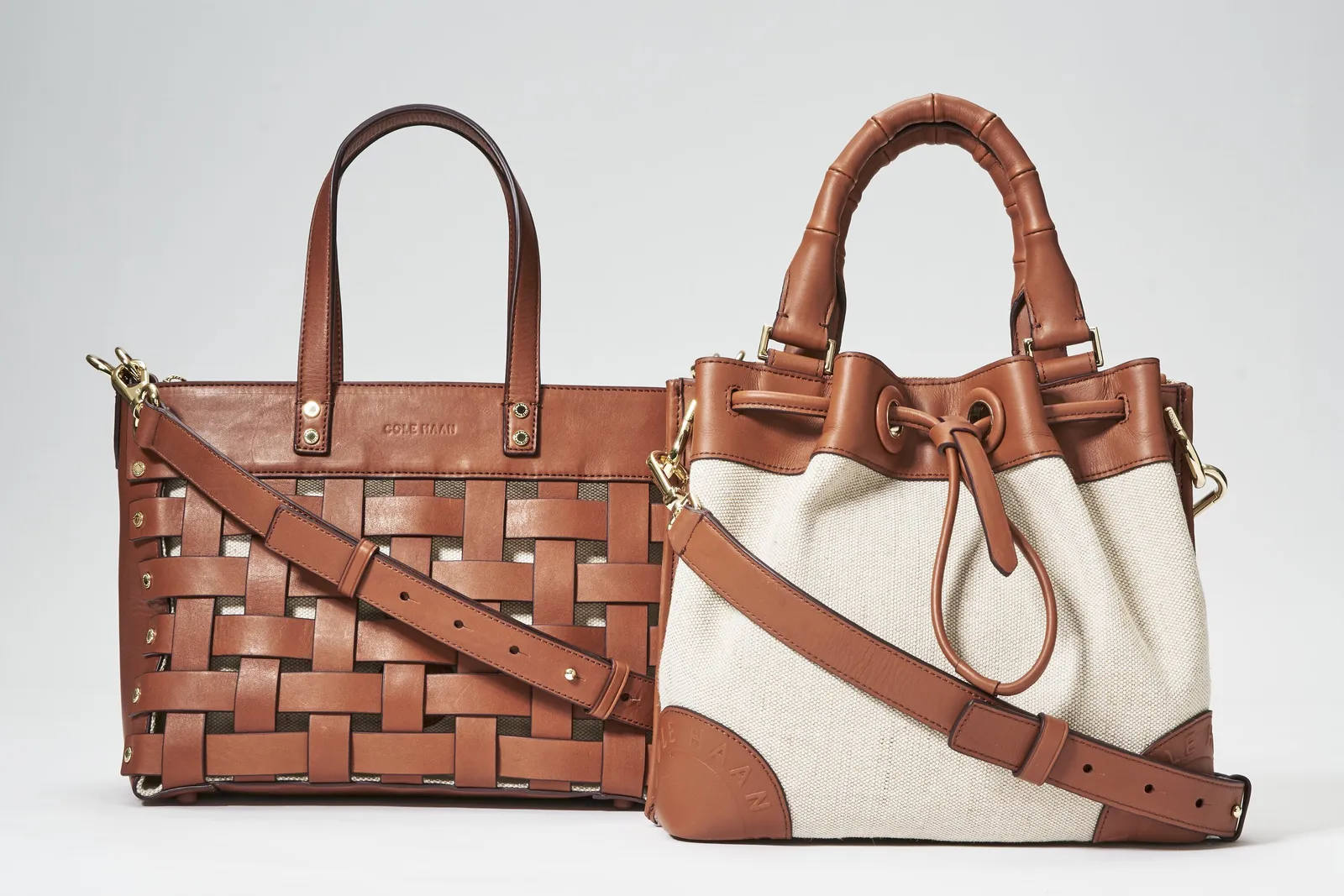 a tan woven-leather tote next to a cream canvas bucket bag with brown leather trim and a drawstring